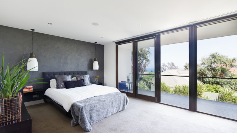 Spacious interior of designer master bedroom in luxury contemporary Australian home
